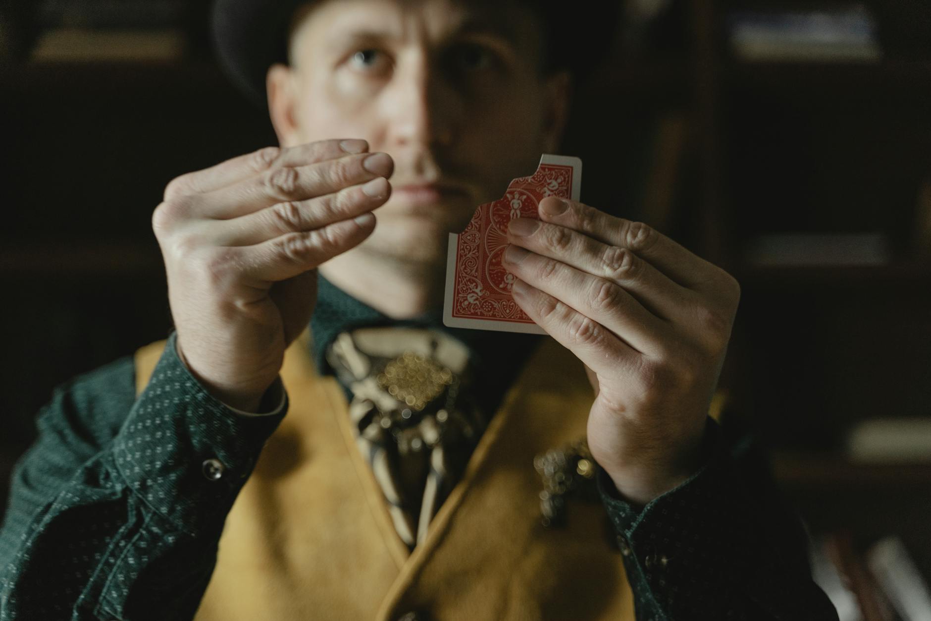 photo of a man doing a card magic trick