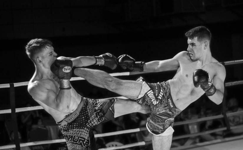 men fighting in the ring