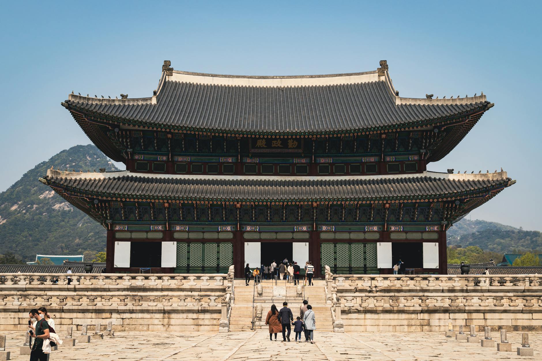 people visiting a temple palace in south korea