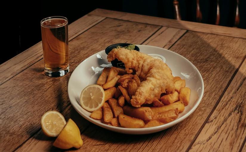 fish potato chips and lemon slice on plate