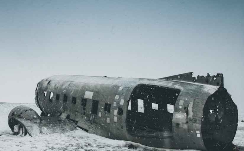 ruined airplane cabin on snowy land under sky