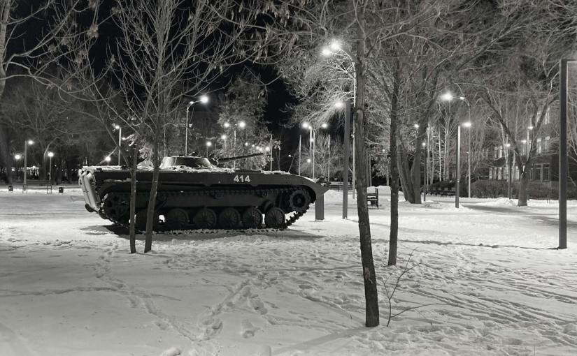 grayscale photo of a tank near trees