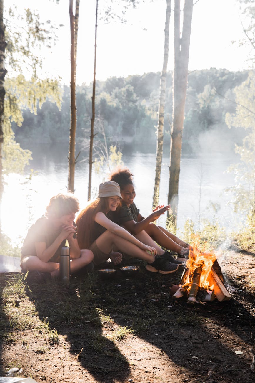 happy children making campfire in forest